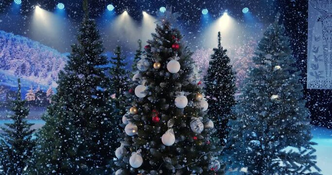 Snow falls on a decorated Christmas tree
