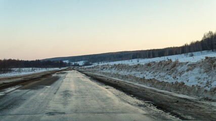 Russia. Spring broken road. The snow is melting, mud is everywhere.