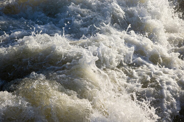 Churning white water river rapids