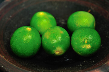 Fresh Key Limes. Lime on a wooden chopping board. Selective focus