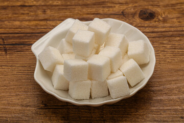 Refined white sugar cubs in the bowl