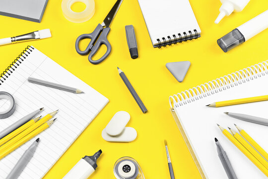 Assorted gray office and school stationery office supplies on yellow desk. Selective focus banner. education craft art or back to school. notebook. Illuminating and bright copy space grey monochrome