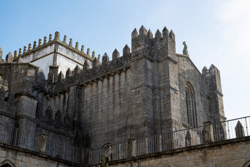 Fototapeta na wymiar Porto cathedral seen from the inner courtyard. Building made of stone Blue sky.