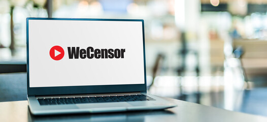 Laptop computer displaying "we censor" sign