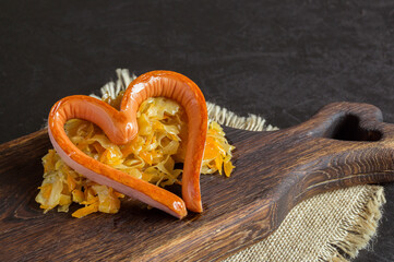 braised pickled cabbage with grilled sausage in the shape of a heart.