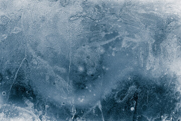 Ice texture background. The textured cold frosty surface of ice block on dark background.