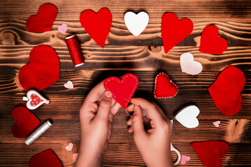 Valentines diy. Step by step instructions for handmade valentine. Craft gift, flat lay. Step 5. Sew the heart of a two-part felt.