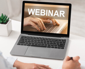 Lady studying online, using laptop, attending webinar