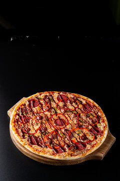 Top view of pizza with spanish sausages and hot chili sauce, ad photo