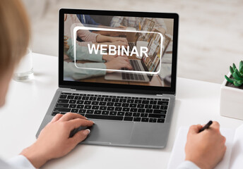 Unrecognizable woman studying online on laptop, attending webinar