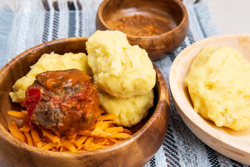 Ugly and sukuma wiki, maize flour porridge with meat and sweet potatoes, Zambian cuisine, Traditional African dishes