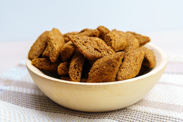 dark croutons close-up in a wooden bowl. Close-up. Selective focus.