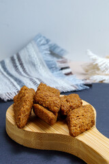 dark croutons close-up on a wooden board. Close-up. Selective focus. vertical photo