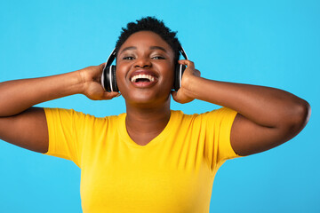 Happy Oversized Black Lady In Headphones Listening Music In Studio