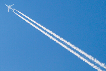An airplane cross above Dreamland Beach, Bali Indonesia. Creating a beautiful trails. 