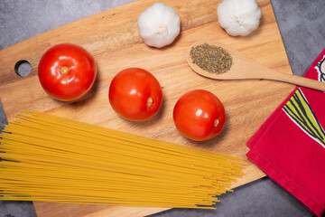 ingredients for pasta meal on wood cutting board