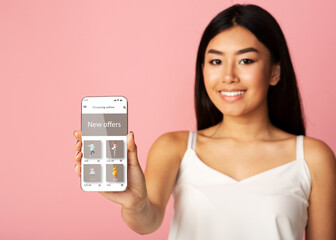 Asian lady showing phone with online fashion store website