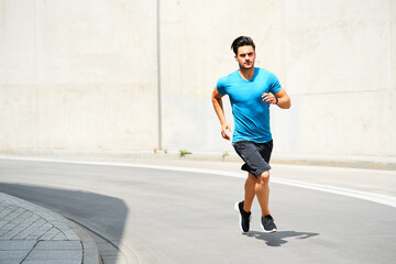 Running exercise during sunny weather in the city