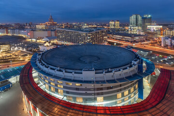 Top view of the ice stadium with the night city at the background