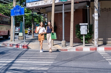 Two young women walking with shopping bag,Consumerism and People,Shopping and Tourism Concept.