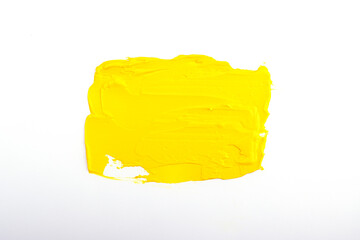 a spot of yellow oil paint isolated on a white background