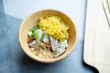 Dry Chinese egg yellow noodles topping minced pork and liver
