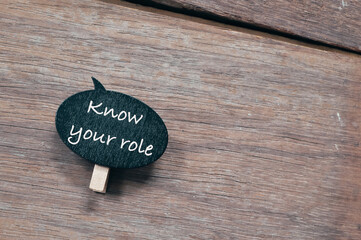 Top view of wooden board written with text KNOW YOUR ROLE.  Business concept. 