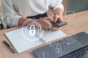 A woman programmer is browsing the Internet in smart phone to protect a cyber security from hacker...