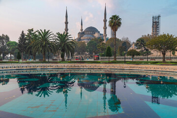 Beautiful view on Blue Mosque or Sultanahmet Camii in Istanbul, Turkey with reflection in fountain on sunrise