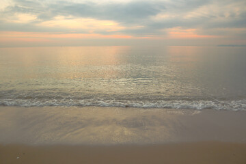 Fototapeta na wymiar Beautiful sand beach background with soft wave on twilight sky.
