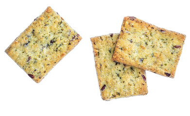 Salted crackers isolated on white background. Crushed dry cracker cookies with herbs, top view.