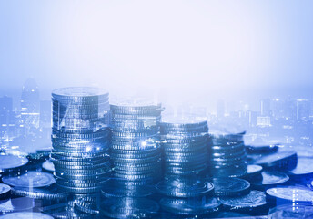 row of coin stack with double exposure night city background for financial banking and saving money and business stock investment concept.
