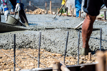 image of Construction workers are pouring a building foundation or house. Concrete works with the...