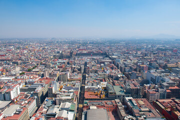 Fototapeta na wymiar Mexico National Flag on Zocalo Constitution Square and Metropolitan Cathedral aerial view, from Torre Latinoamericana, Mexico City, Mexico. Historic center of Mexico City is a World Heritage Site. 