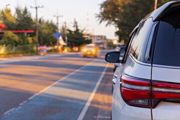 Close up back of car and on the road. Cars on highway. Car headlight. car parking on local road.