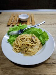 composition italian noodles with green lettuce