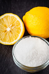 citric acid on a dark stone background