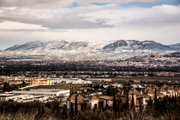 Obraz premium landscape with snowy mountains and Granada city line