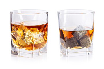 Glasses of whiskey with stones and ice isolated on white