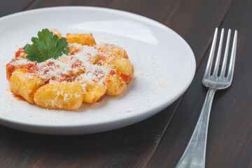 Naklejka premium gnocchi with ragù in white porcelain plate