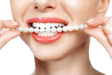 Beautiful female teeth smile and pearl necklace, Dental Health Concept Teeth whitening. Dental clinic patient. Image symbolizes oral care dentistry, stomatology. Isolate en white backround.