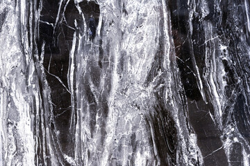 Black quartz stone with white stripes. Natural quartz background and texture.