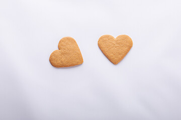 Two heart-shaped cookies on the white background.