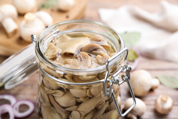 Glass jar of tasty pickled mushrooms, closeup