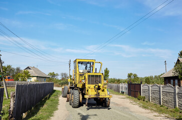 Fototapeta na wymiar Road grader - heavy earth moving road construction equipment