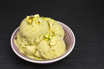 fresh green pistachio ice cream scoops in a bowl