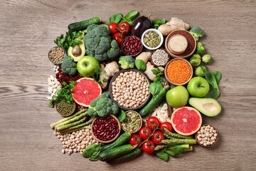 Fresh vegetables, fruits and seeds on wooden table, flat lay