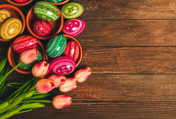 Colorful Easter eggs on wooden background. Happy Easter. Space for text.