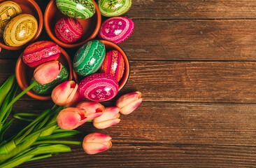 Colorful Easter eggs on wooden background. Happy Easter. Space for text.