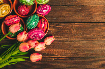 Colorful Easter eggs on wooden background. Happy Easter. Space for text.